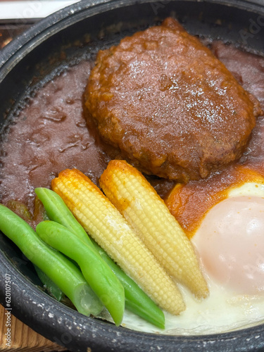 Japanese style hamberger or hamberg serve with gravy sauce and vegetables