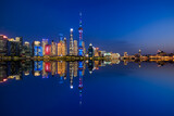 Beautiful Shanghai skyline and modern buildings scenery at night, China. modern city buildings and water reflection.