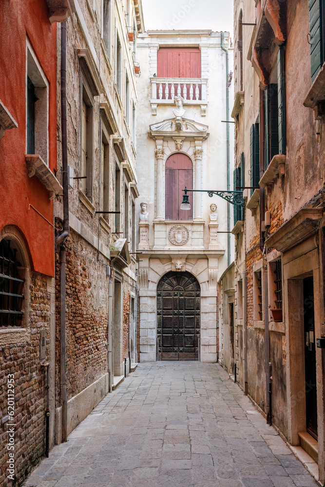 Fototapeta premium Narrow street in the historical center of Venice, Italy, Europe.