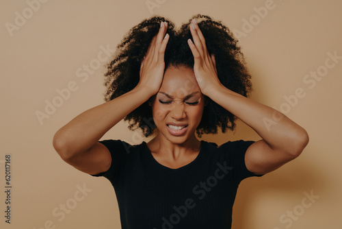Shocked panic African American girl dressed in black T-shirt holding hands on he Fototapet