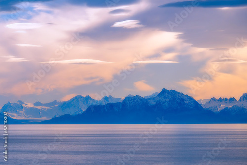 Landscape mountain view with beautiful clouds on sky of Patagonia and river as foreground in autumn in South America. Peaceful.