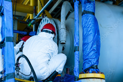 Obraz na plátně Worker cleaning internal pressure vessel in confine space.