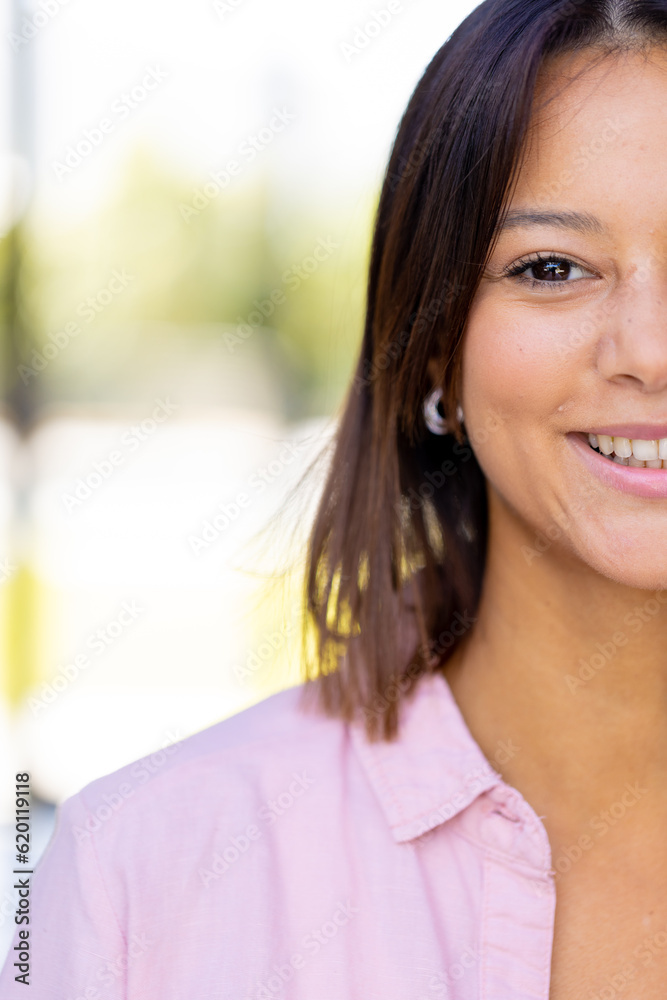 Portrait of happy biracial woman looking at camera and smiling, copy space