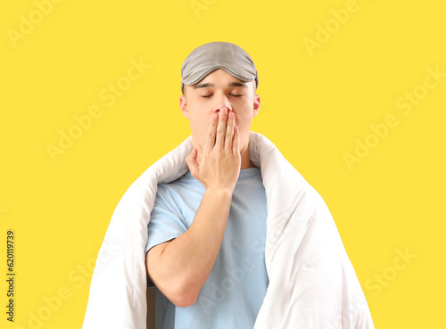 Sleepy young man with mask ...