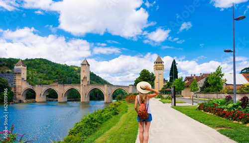 Woman looking at the Valentre bridge in Cahors town - France