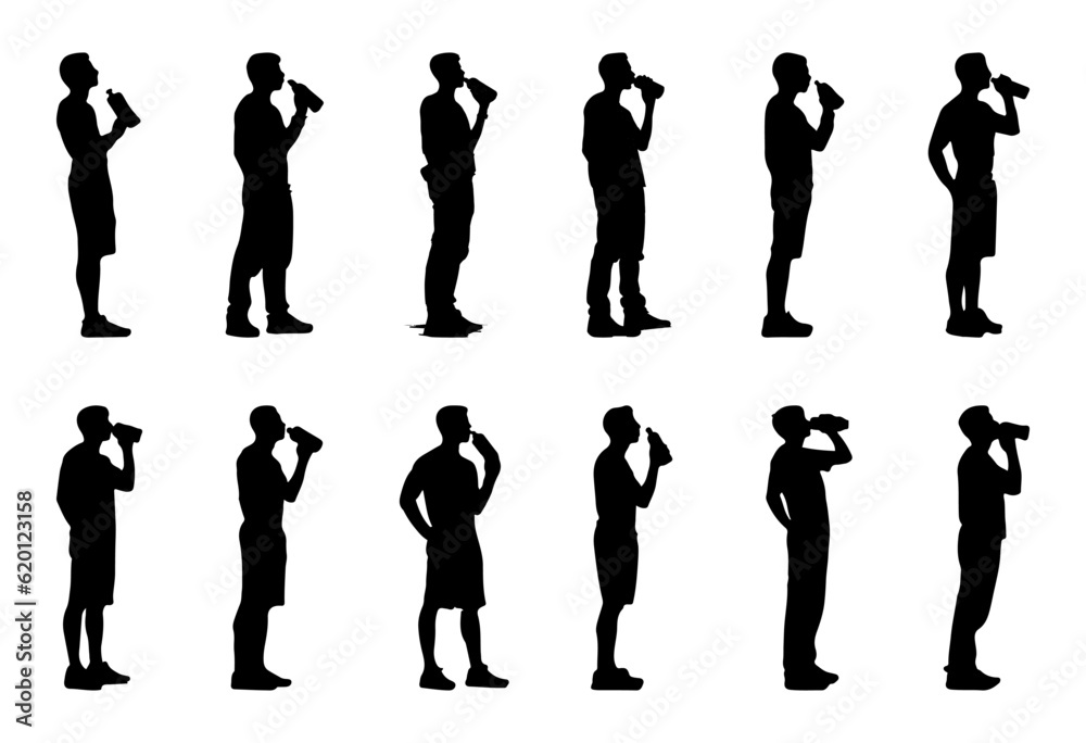silhouette of man standing drinking water from bottle