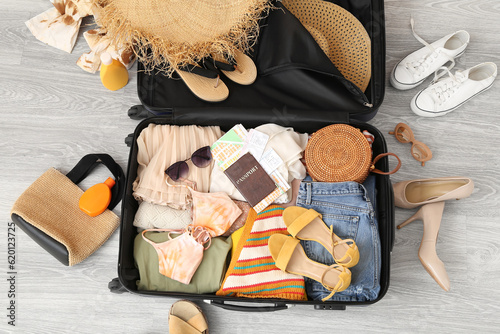 Suitcase with clothes, beac...