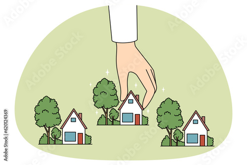 Real estate agent working with small house miniatures. Realtor or broker hand holding homes maquettes. Realty and rent concept. Vector illustration.