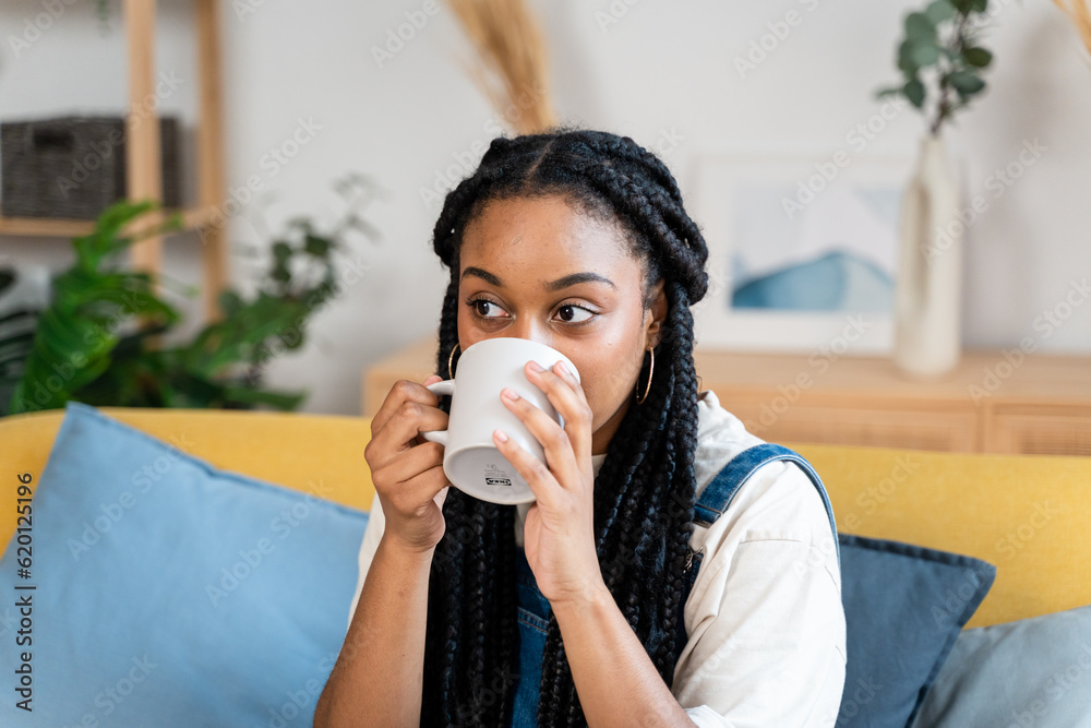 African american woman having a cup of coffee at home. African american woman having a cup of coffee at home.