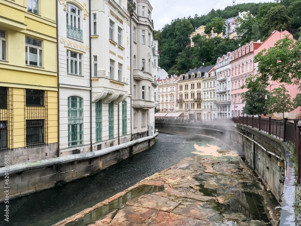Tepla creek channel in Karlovy Vary with hot water from springs making steam at Vridelni street