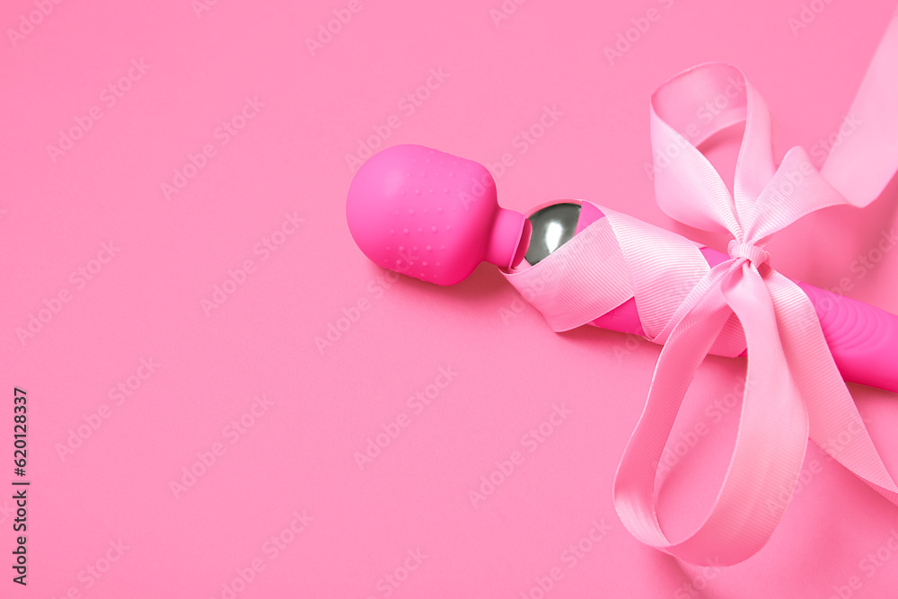 Vibrator with beautiful bow on pink background Vibrator with beautiful bow on pink background