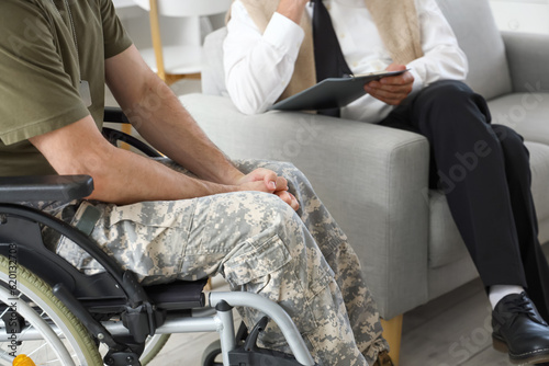 Male soldier in wheelchair at psychologist's office, closeup