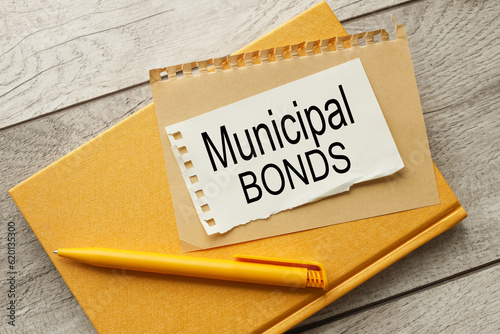 MUNICIPAL BONDS view from above. on torn paper with text on white on a yellow notepad.