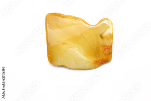 Matte amber on the white background. Sun stone. Fossil fossilized resin. semi-precious mineral. Natural material for jewelry. Copal. Science.  Polished amber stone. Fly and mosquito