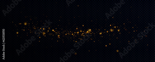 Golden sequins glow with many lights. Glittering dust. Luxurious background of golden particles.