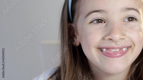 Brave cheerful girl opens his mouth wide to the doctor to show his throat.