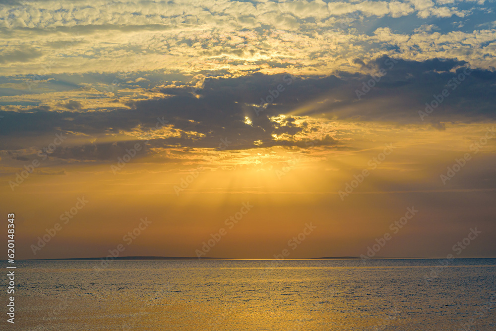 Naklejka premium A beautiful sunset on the sea is reflected in the water.