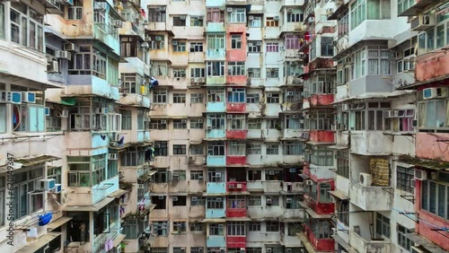 Yick Cheong and Yick Fat old apartment house exterior architecture in Hong Kong city, drone aerial view. Asian people residential life, transformer building or monster building travel landmark photo