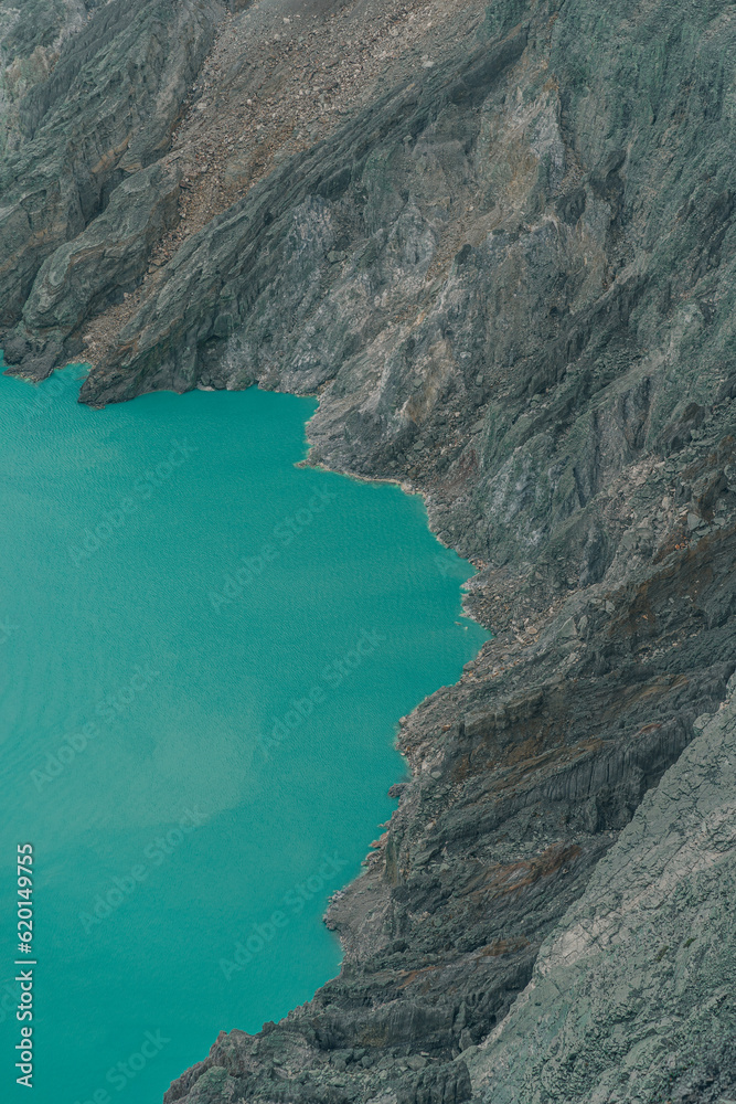 Top view of blue lake in the mountains. Scenic beautiful view of lagoon surrounded by hills