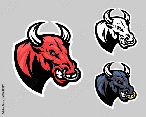 Angry bull head emblem with red, black and black and white color variations. 