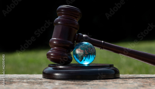 Glass globe and judge's gavel photo