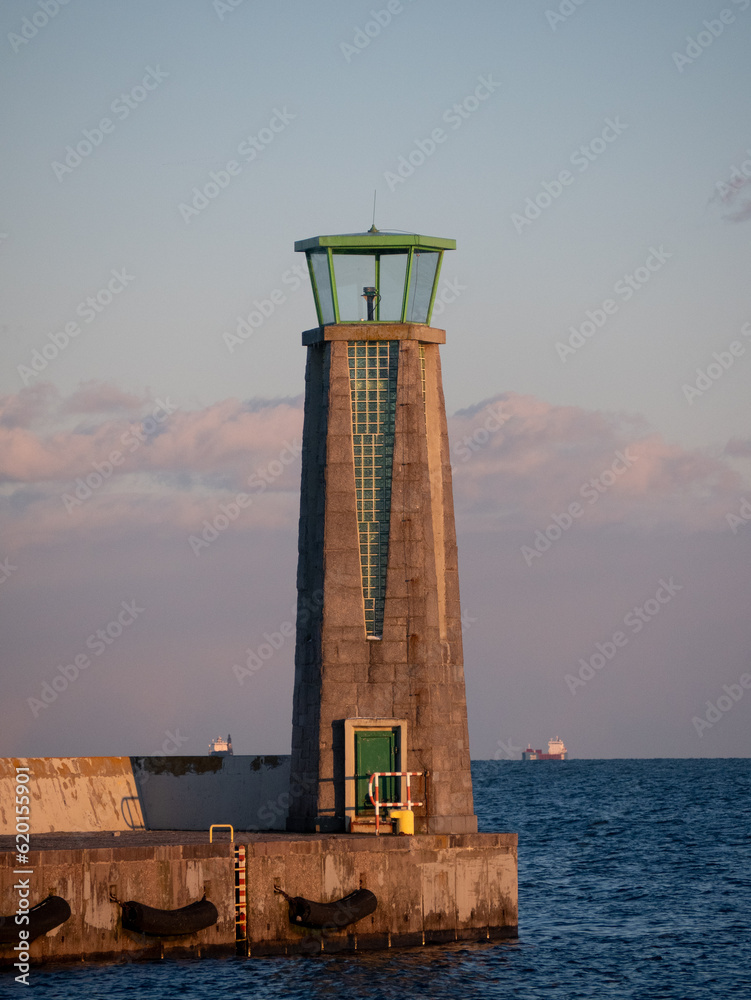 A lighthouse with glassbricks and green dome in Gdynia, Poland.