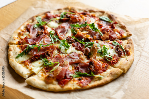 Fresh pizza with bacon on wooden table