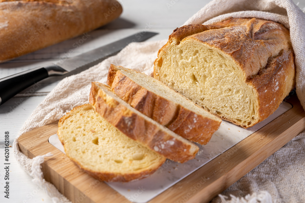 Bakery - Freshly baked bread on rustic wooden background. Sliced ​​bread. 