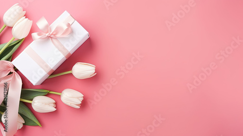 Valentines day mothers day background. Spring white tulip flower, gift box with red ribbon on flat lay pink background. Top view wedding love minimal concept © Absent Satu