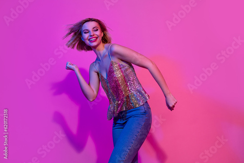 Photo of positive cheerful lady dance energetic dynamic on nightlife party event isolated vibrant neon color background