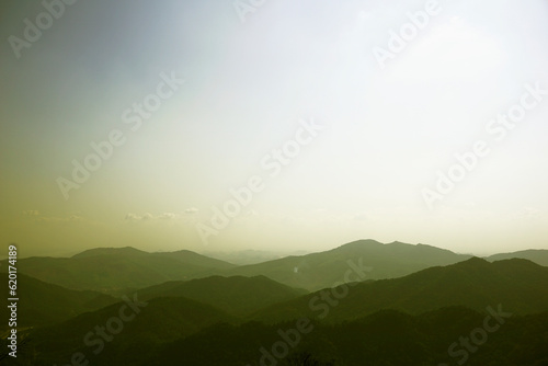 Mountain range in foggy sky background © hippomyta