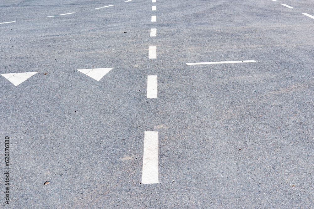 Level asphalted road with a dividing stripes,urban car guide strips.