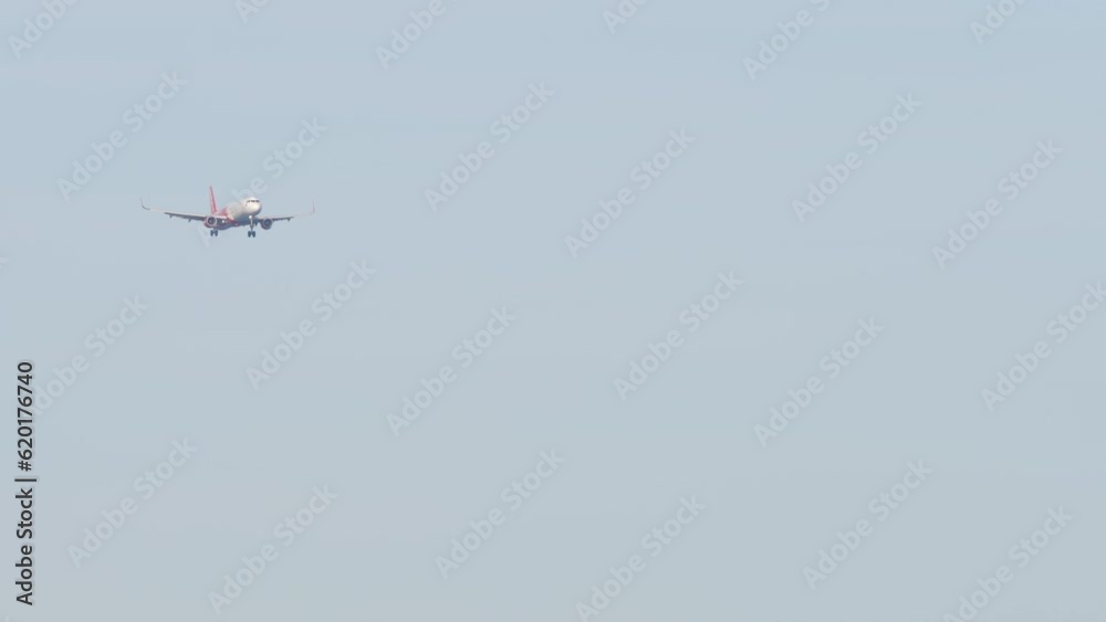 Shot of passenger jet aircraft approaching before landing. Commercial airplane flies. Background of plane in sky. Aviation concept Shot of passenger jet aircraft approaching before landing. Commercial airplane flies. Background of plane in sky. Aviation concept