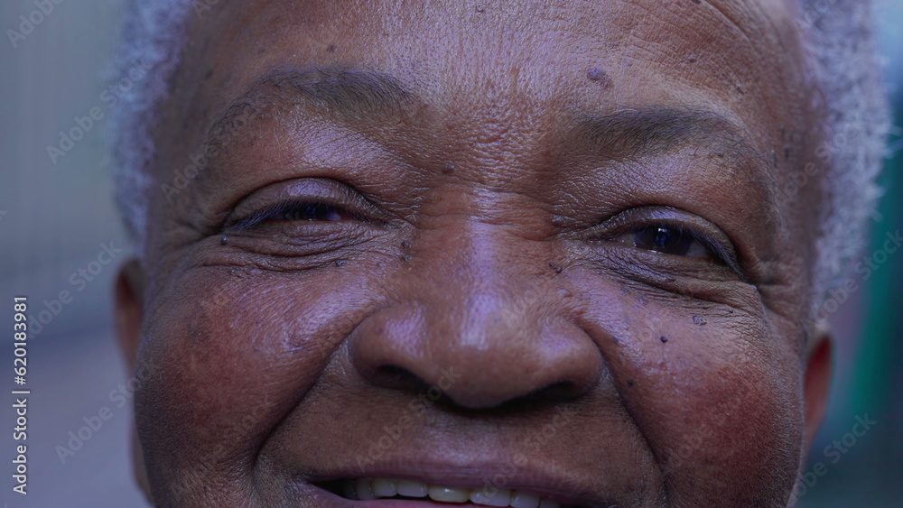 Macro close-up of a joyful black Brazilian woman eyes smiling at camera