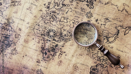 Magnifying glass and an ancient old map,Old map with an magnifying glass