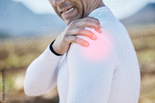 Biker, hand or man with shoulder pain, injury or inflammation outdoors with torn muscle, strain or bruise. Cyclist, injured or sports athlete with accident, red glow or emergency in training practice