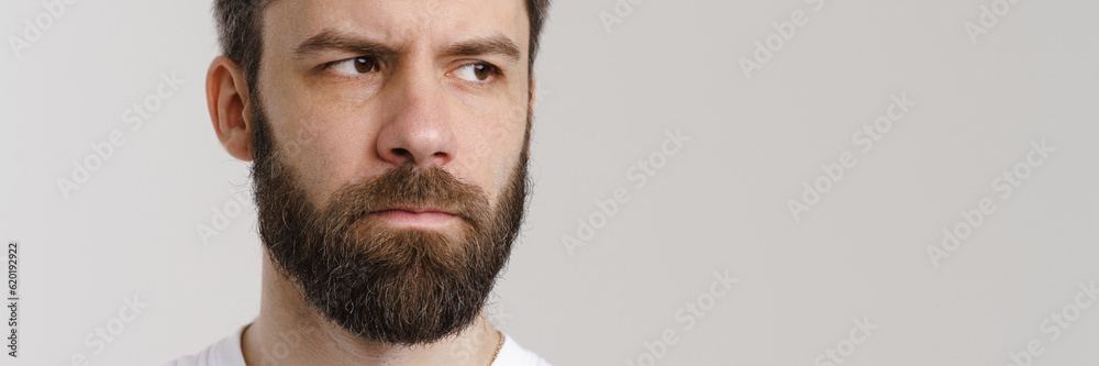 Bearded puzzled man with beard posing and looking at camera Bearded puzzled man with beard posing and looking at camera
