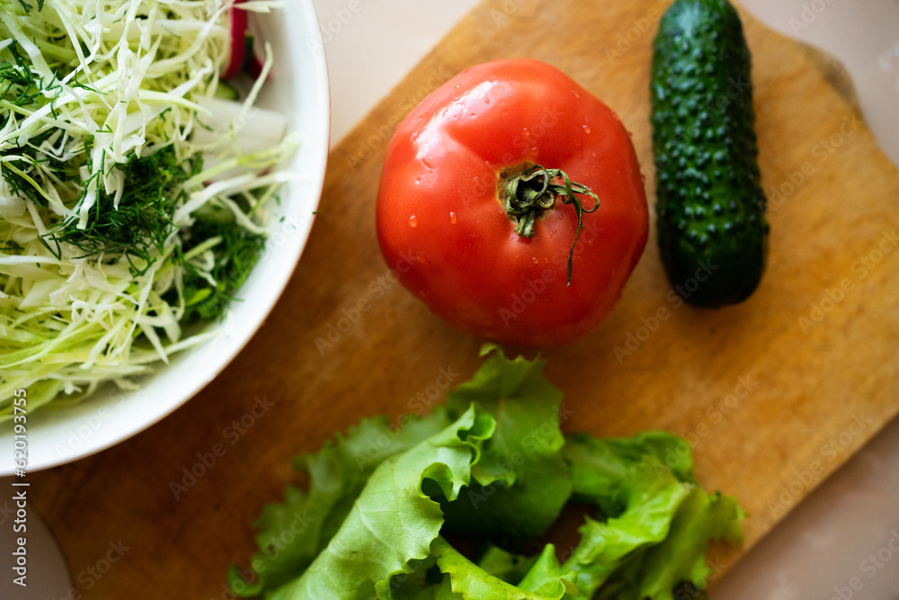 salad, cucumber, posymore and greens on a wooden board. fresh farm products for a healthy lifestyle and diet salad, cucumber, posymore and greens on a wooden board. fresh farm products for a healthy lifestyle and diet