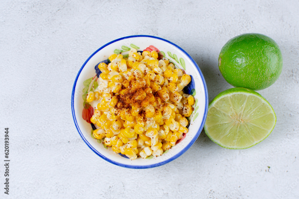 Sweet maicitos in cheese sauce, Mexican dish, accompanied by lemon wedges Sweet maicitos in cheese sauce, Mexican dish, accompanied by lemon wedges