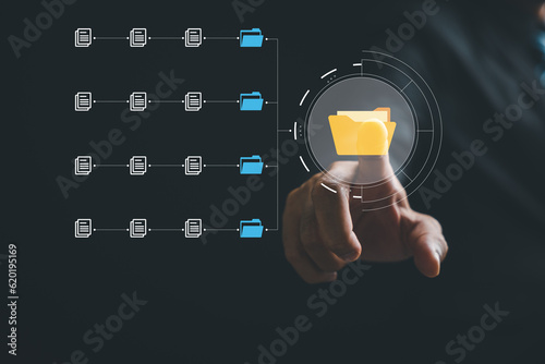 Businesswoman pointing to a digital screen featuring Document Management System (DMS). Streamlined file archiving and efficient information management. Leveraging internet for enhanced productivity.