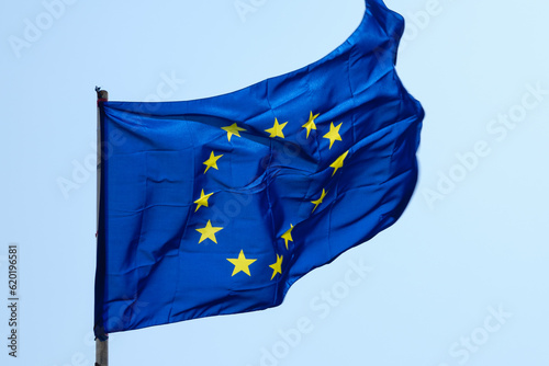 Close-up shot of the flag of the European Union with the circle of yellow stars representing the number of nations.