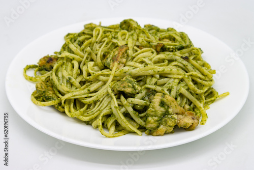 Linguini Pesto Pasta with Chicken on a White Plate