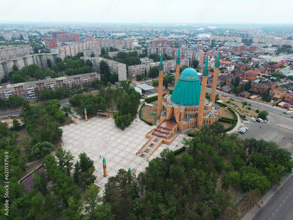 Mashkhur Jusup Mosque in the center of Pavlodar on a blue sky background in summer. top view from the drone from above