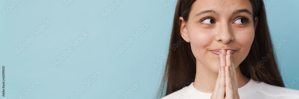 Young white brunette woman smiling and holding her palms together Young white brunette woman smiling and holding her palms together
