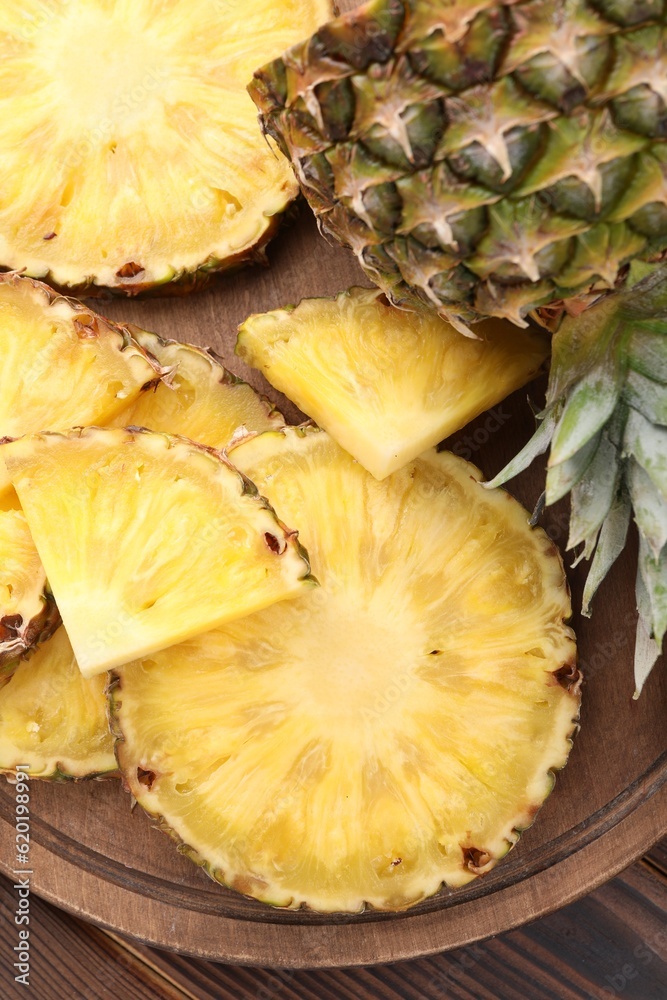 Pieces of tasty ripe pineapple on table, top view Pieces of tasty ripe pineapple on table, top view