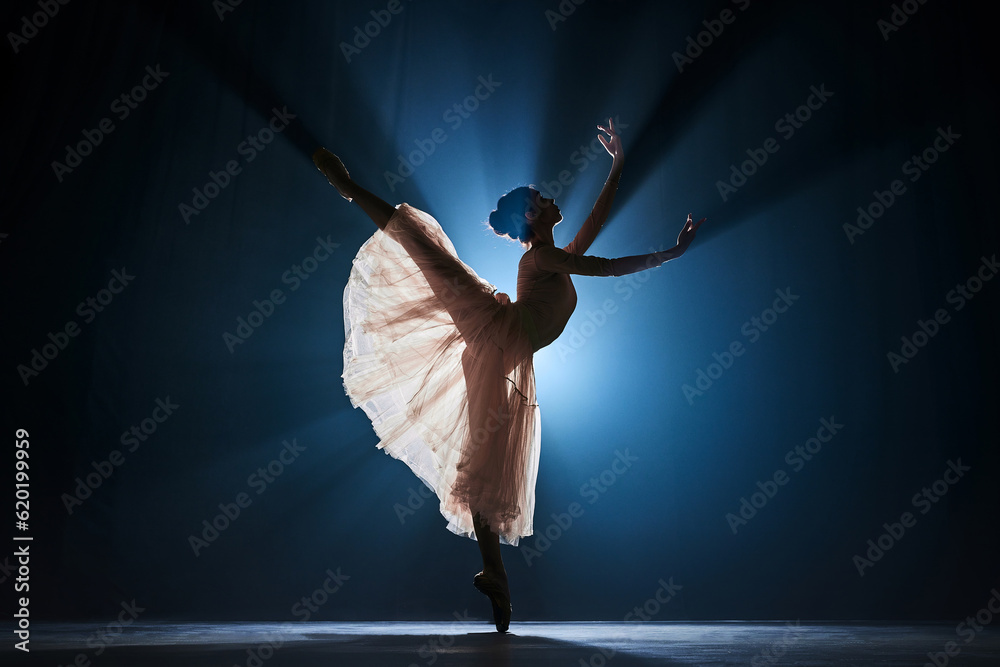 Elegant, tender, slim, talented girl, female ballet dancing dancing against dark blue background with spotlight - obrazy, fototapety, plakaty 