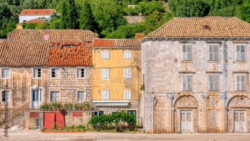 Traditional stone houses along the waterfront street in the picturesque village of Sipanska Luka on Sipan Island on the Dalmatian Coast in Croatia.