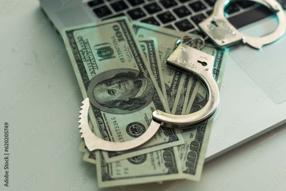 Police handcuffs in US dollars and euros. Police handcuffs in US dollars and euros.