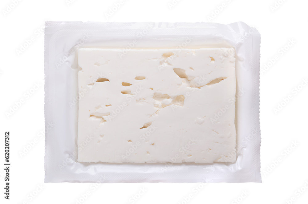 Greek feta block, brined cheese, in its opened original plastic wrap. Cheese, matured in brine, with soft and moist texture, and with fresh, salty and acidic taste. Isolated, from above, food photo.