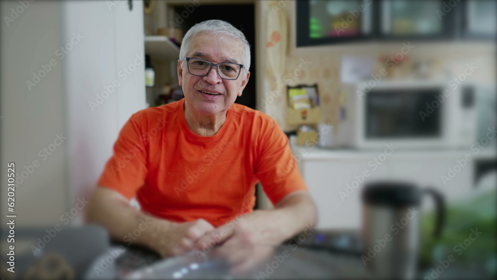 Portrait of a senior man in kitchen setting, elderly person looking at camera in domestic scene Portrait of a senior man in kitchen setting, elderly person looking at camera in domestic scene